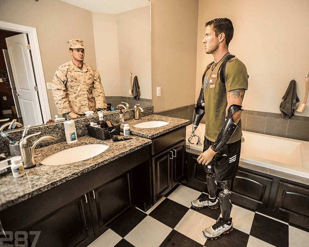 Marine looking at past self in mirror